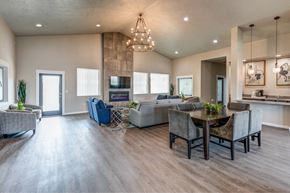 Post Falls apartment for rent - A modern living room with a dining area and a kitchen in the background.