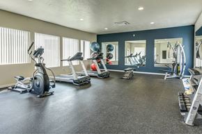Post Falls apartment for rent - A spacious gym with a variety of equipment including treadmills, elliptical machines, and weight machines.