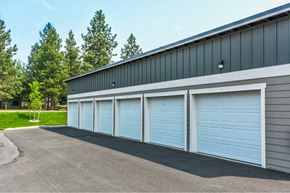 Post Falls apartment for rent - A building with four white garage doors.