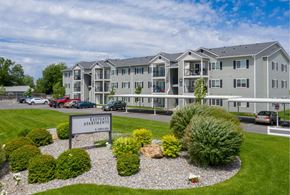 Spokane Valley apartment for rent - A building with the sign "Fairway Apartments" in front of it.