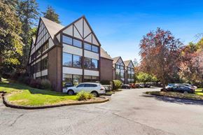 Spokane apartment for rent - A modern building with a parking lot in front.