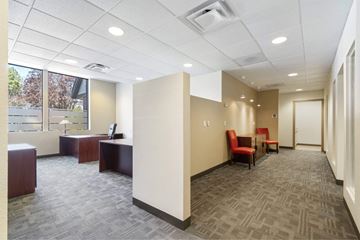 Spokane apartment for rent - A conference room with a carpeted floor and a window.