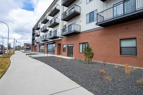 Post Falls apartment for rent - A long building with balconies on the second floor.