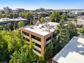 Spokane apartment for rent - A building with a flat roof surrounded by trees.
