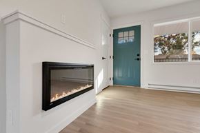 Coeur D'alene apartment for rent - A room with a fireplace and a blue door.