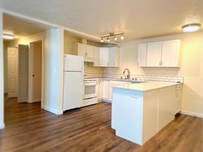Spokane apartment for rent - A kitchen with white appliances and cabinets.