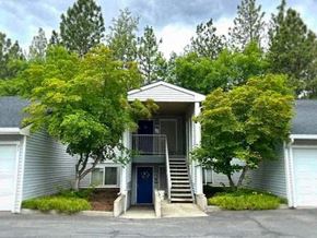 Spokane apartment for rent - A house with a blue door and a porch.
