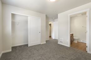 Post Falls apartment for rent - A sparsely furnished bedroom with a carpeted floor and white walls.