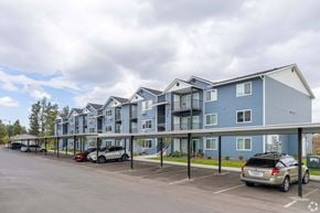 Spokane apartment for rent - A row of modern townhouses with cars parked in front.