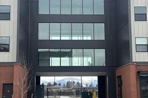 Post Falls apartment for rent - A modern building with a large glass window entrance.