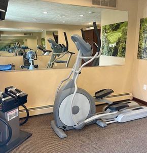 Spokane Valley apartment for rent - A gym with a treadmill, elliptical trainer and a stationary bike.