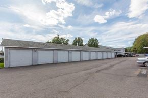 Spokane Valley apartment for rent - A parking lot with garages and cars.
