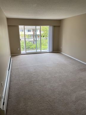 Burnaby apartment for rent - an empty living room with a balcony