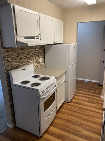 Burnaby apartment for rent - A kitchen with a stove and cabinets.