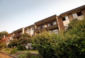 Coquitlam apartment for rent - a row of apartment buildings with bushes in front of them