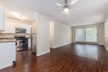 Burnaby apartment for rent - A kitchen with white cabinets and a stainless steel refrigerator.