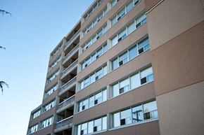 New Westminster apartment for rent - A tall building with many windows and balconies.