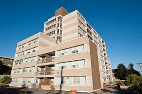 New Westminster apartment for rent - A tall residential building with balconies and multiple floors.
