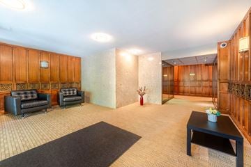 Vancouver apartment for rent - A living room with a black sofa and a coffee table.