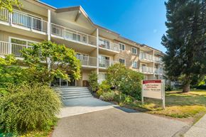 Burnaby apartment for rent - A building with a sign that says "Cold Springs Apartments" in front of it.