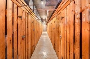 Vancouver apartment for rent - A long hallway with wooden walls and a concrete floor.