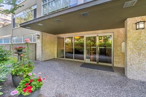Vancouver apartment for rent - A patio area with a glass door entrance and a potted plant.