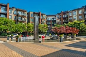 North Vancouver apartment for rent - A fountain in the middle of a brick square with apartment buildings in the background.