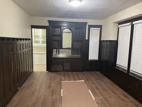 Milwaukee apartment for rent - A room with dark wood floors and furniture.