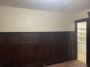 Milwaukee apartment for rent - A brown wooden door with a white wall behind it.