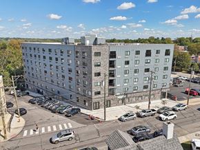 Philadelphia apartment for rent - A large building with a parking lot in front of it.