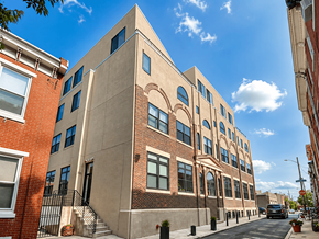 Philadelphia apartment for rent - A street view of a building with a clear blue sky above.