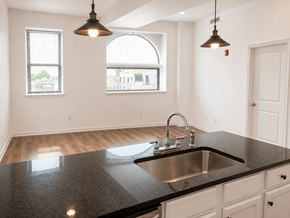 Philadelphia apartment for rent - A kitchen with a black countertop and a window.