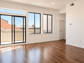 Philadelphia apartment for rent - A room with a wooden floor and a large window.