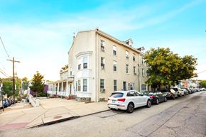 Philadelphia apartment for rent - an apartment building on a city street with parked cars