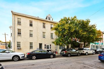 Philadelphia apartment for rent - a large brick building with cars parked in front of it