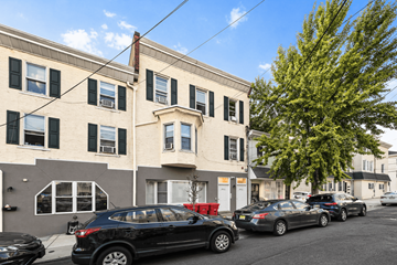 Philadelphia apartment for rent - A black SUV is parked in front of a building with a tree to the right.