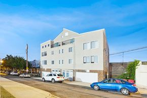Philadelphia apartment for rent - a white building with a blue car parked in front of it