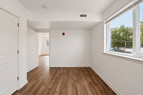 Philadelphia apartment for rent - A room with a white door and a window with a view of trees outside.
