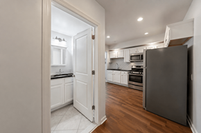 Philadelphia apartment for rent - A kitchen with a refrigerator on the right and a doorway leading to another room.