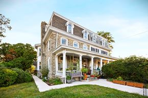 Philadelphia apartment for rent - a large brick house with a porch and a lawn