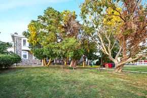 Philadelphia apartment for rent - a yard with trees and a house in the background