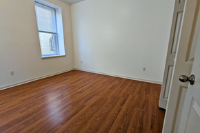 Philadelphia apartment for rent - an empty bedroom with wood floors and a window