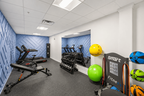 Philadelphia apartment for rent - A gym with a row of exercise bikes, a green exercise ball, and a sign that says "smart fitness".