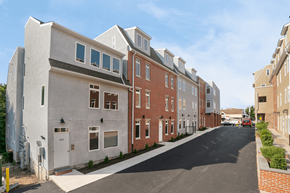 Philadelphia apartment for rent - A row of townhouses with a car parked on the street.