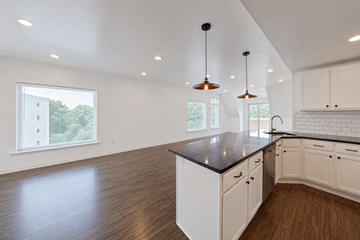 Philadelphia apartment for rent - A kitchen with white cabinets and a black countertop.