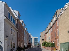 Philadelphia apartment for rent - a city street with brick buildings and a clear blue sky
