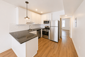 Philadelphia apartment for rent - A kitchen with a refrigerator, microwave, and oven.