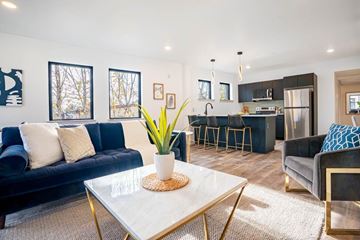 Philadelphia apartment for rent - A modern living room with a blue sofa and a white coffee table.