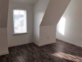 Philadelphia apartment for rent - an empty living room with wood floors and a window