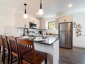 Philadelphia apartment for rent - an open kitchen and dining area with a island and stainless steel refrigerator